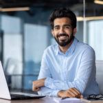 ESG analyst working on a laptop in a modern office, symbolizing sustainable investment analysis