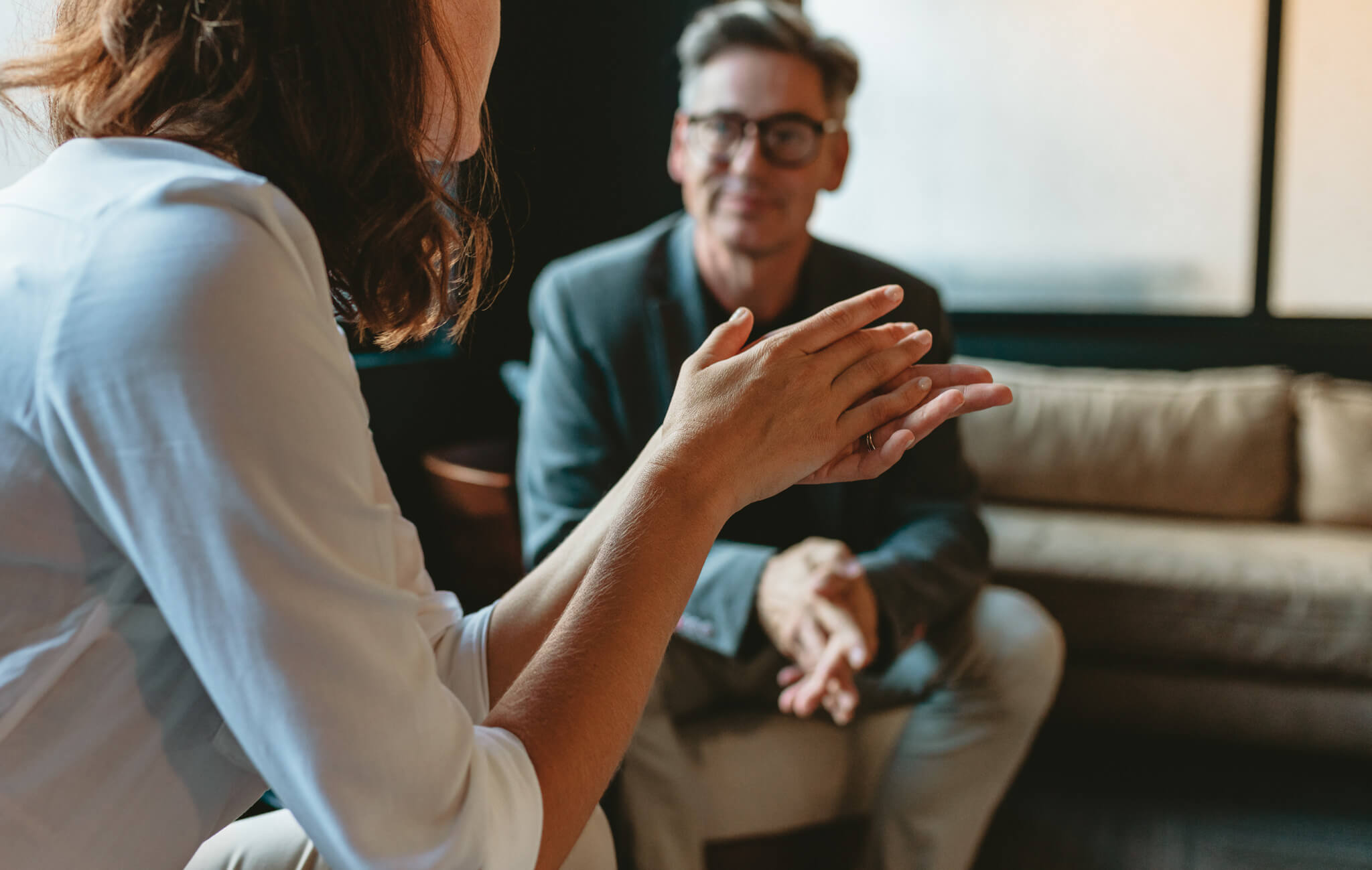 Close-up of two analysts in discussion, representing collaboration in ESG analysis and AI chatbot investment